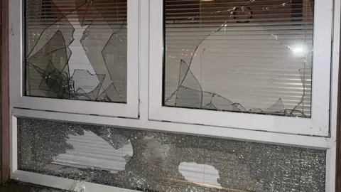 Three window panes with broken glass