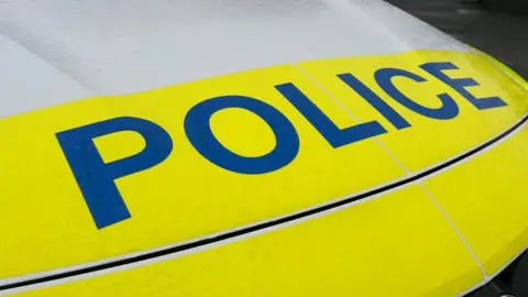 a close up of the front of a yellow police car.