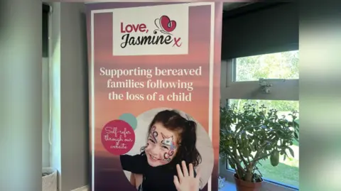 Love, Jasmine poster with a photo of Jasmine. It reads: 'Supporting bereaved families following the loss of a child. Self-refer through our website'