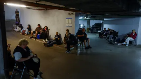 Reuters People take shelter inside an underground parking during Russian missile and drone strikes, amid Russia's attack on Ukraine, in Kyiv, Ukraine August 20, 2026