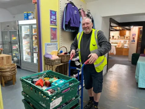 Jon Wright/BBC Mark Gardener moving creates of food into the main room at Project40Seven 