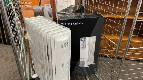 BBC An oil-filled radiator, inside a retail cage at a shop 