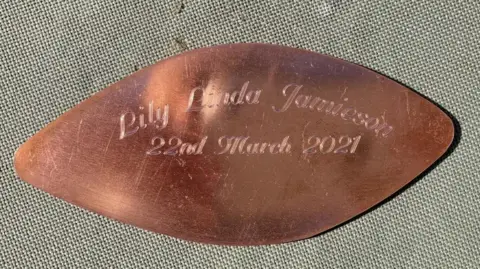 Eilidh Jamieson A brass leaf inscribed with the words Lily Linda Jamieson 22nd March 2021