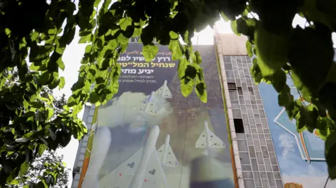 EPA A billboard in Tehran showing Iranian drones, captioned 'Tel Aviv will not be safe from now on'