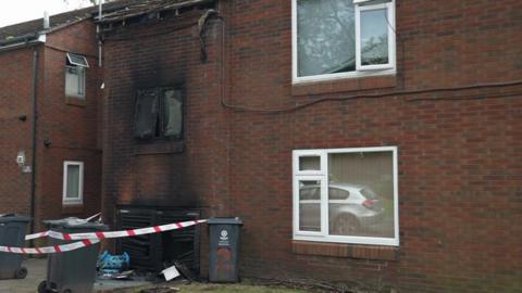 A cordon outside a property with fire damage