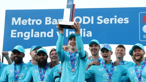 England captain Harry Brook (centre) holds up the ODI series trophy