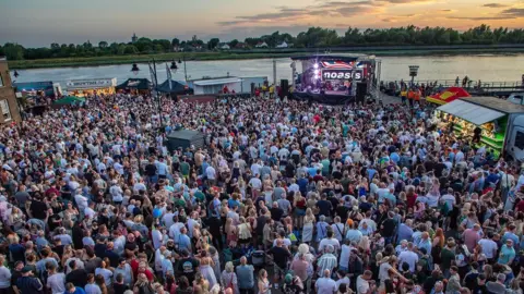 An aerial view of the Quayside in King's Lynn at sunset which filled with people watching an Oasis tribute band