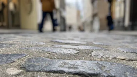 The picture shows cobbled streets in Guernsey's St Peter Port