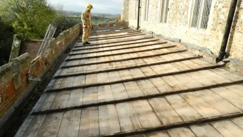 Peter Goodridge Firefighter on top of church roof