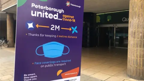 A sign reminding people to social distance in Peterborough