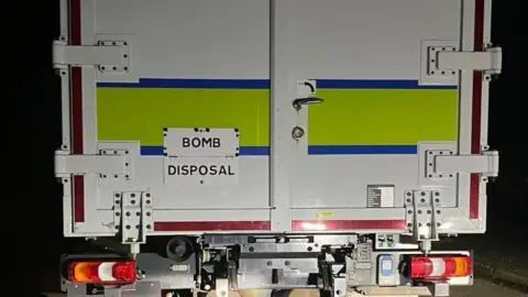 The back of a van which says "BOMB DISPOSAL" on it.