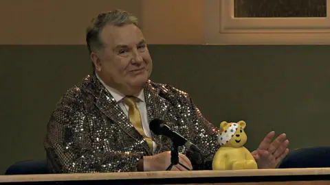 BBC A picture of Russell Grant in a gold jacket