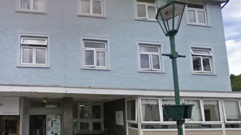 Google Exterior of Moot Lodge Care Home, a three-storey light blue building
