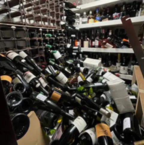 Strathspey Railway Company Wine bottles lying in a pile after falling from a large rack inside a railway coach