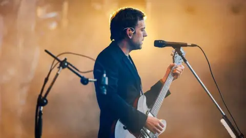 Rogan/Ashton Gate A member of Kings of Leon on stage at Ashton Gate in Bristol