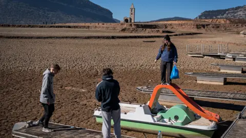 Children playing in an empty reservoir