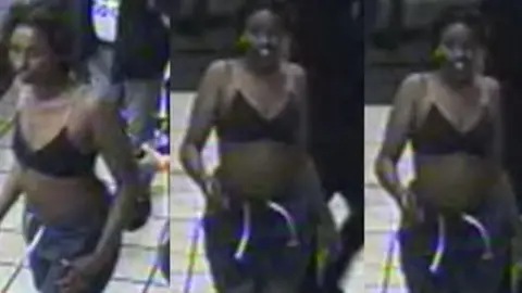 British Transport Police A blurred CCTV image of a woman in a London underground station who is wearing dark coloured bottoms and a black bikini top.
