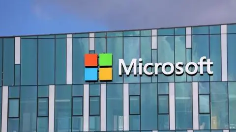 Getty Images A stock image of the Microsoft office. The words "Microsoft" and the company's logo with orange, green, blue and yellow squares can be seen on a blue building. 