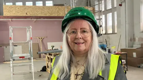 Photograph of the Rochdale councillor Sue Smith. She is pictured inside the Touchstones building, which is undergoing a major refurbishment.
