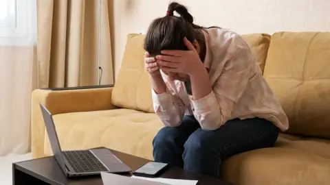 Getty Images Stock photograph of someone worried about a phone bill