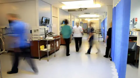 PA Media Hospital staff in a corridor at the Royal Liverpool Hospital