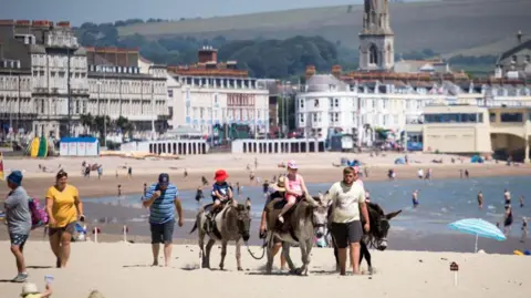 Getty Images People on a beach in Weymouth