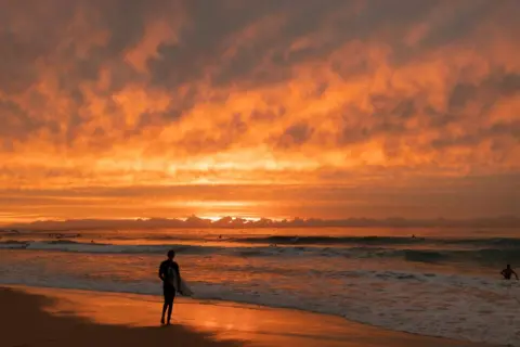 Brook Mitchell / Getty Images A surfer waits to paddle out at Maroubra beach in Sydney, Australia