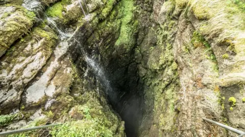 PA Media The opening of Gaping Gill