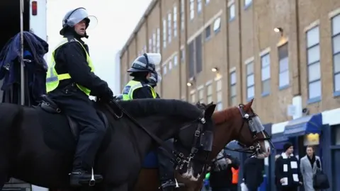 Getty Images Police on horses line up outside the stadium prior to kick off during the match between Tottenham Hotspur and West Ham United at White Hart Lane