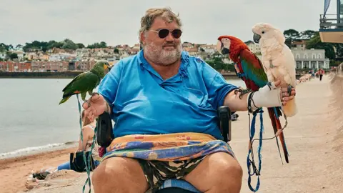 David Hares  A local man takes his parrots out for a ride along Paignton Sea front