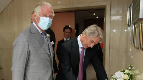 PA Media The Prince of Wales (left) is is greeted by Iceland Executive Chairman, Sir Malcolm Walker, during a visit to the headquarters of Iceland Foods Ltd, Flintshire