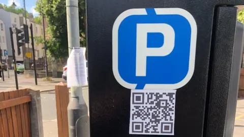 Cheltenham Borough Council Parking ticket machine with QR code close to road
