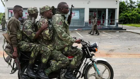 EPA Four soldiers riding a motorbike in Palma