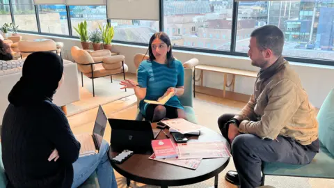 Sonya Barlow having a meeting with colleagues at a WeWork co-working space in the City of London.