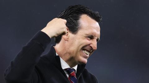 Unai Emery punches the air and smiles.