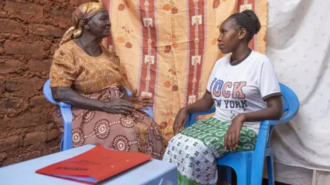 African Academy of Sciences Birth attendant talks with a pregnant woman