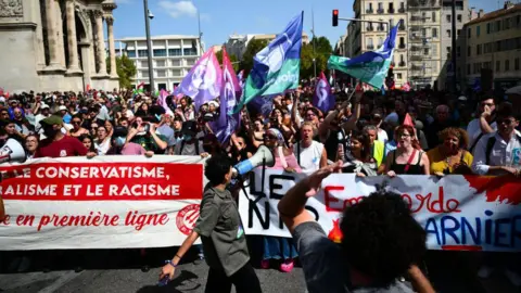 Getty Images People take part in a demonstration against the appointment of right-wing Prime Minister Michel Barnier by France's President Emmanuel Macron in Marseille, southern France, on September 7, 2024.