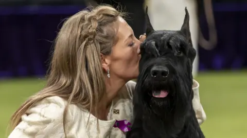 Owner Katie Bernardin - on the left - kissing Monty.