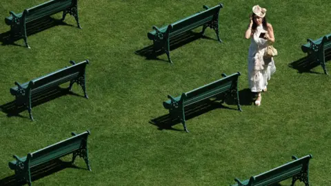 Reuters General view of a racegoer and benches ahead of the day's races at Royal Ascot.