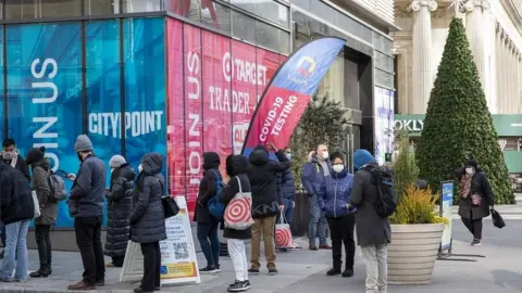 EPA People wait in line to take a COVID-19 test at Albee Square in New York, New York, USA, 23 December 2021