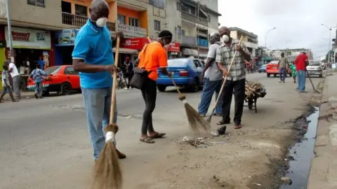 Reuters Volunteers clean a street of Treichville during the world clean up day in Abidjan, Ivory Coast September 15, 2018.