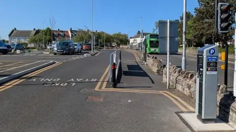 A car park with a pay machine on the right.