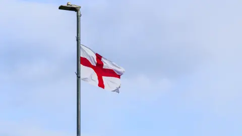 A St George's flag flies from a lamp post