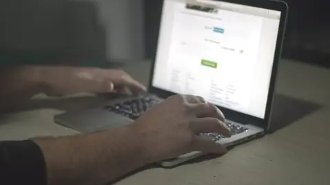 Getty Images Stock photo of unidentified person on laptop