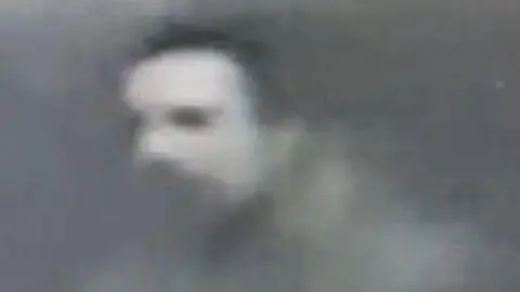 West Midlands Police A grainy CCTV image of the close up of a man's face