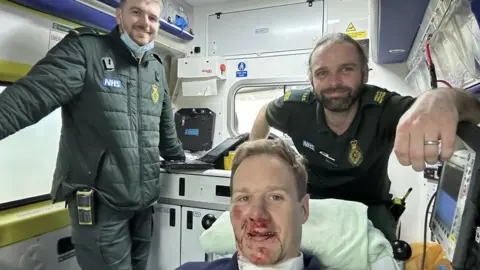 Dan Walker/Twitter Dan Walker in an ambulance with two NHS staff after a car accident