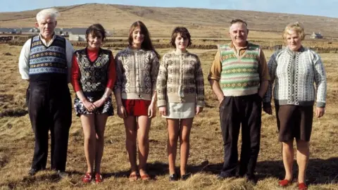 Chris Morphet A family of Shetlanders pose wearing Fair Isle jumpers and tank tops on one of the Shetland Islands in June 1970