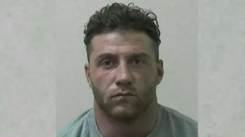 Northumbria Police A police shot of Jake McIntyre in a grey t-shirt