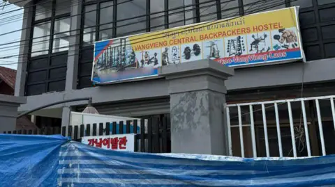 Supplied An image of the former Nana Backpacker Hostel in Laos under construction with a poster advertising it is reopening as the Vang Vieng Central Backpacker Hostel.