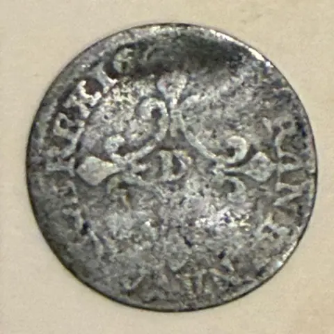 Ian Deveney The picture shows the back of the silver coin and its slightly worn decorative markings.